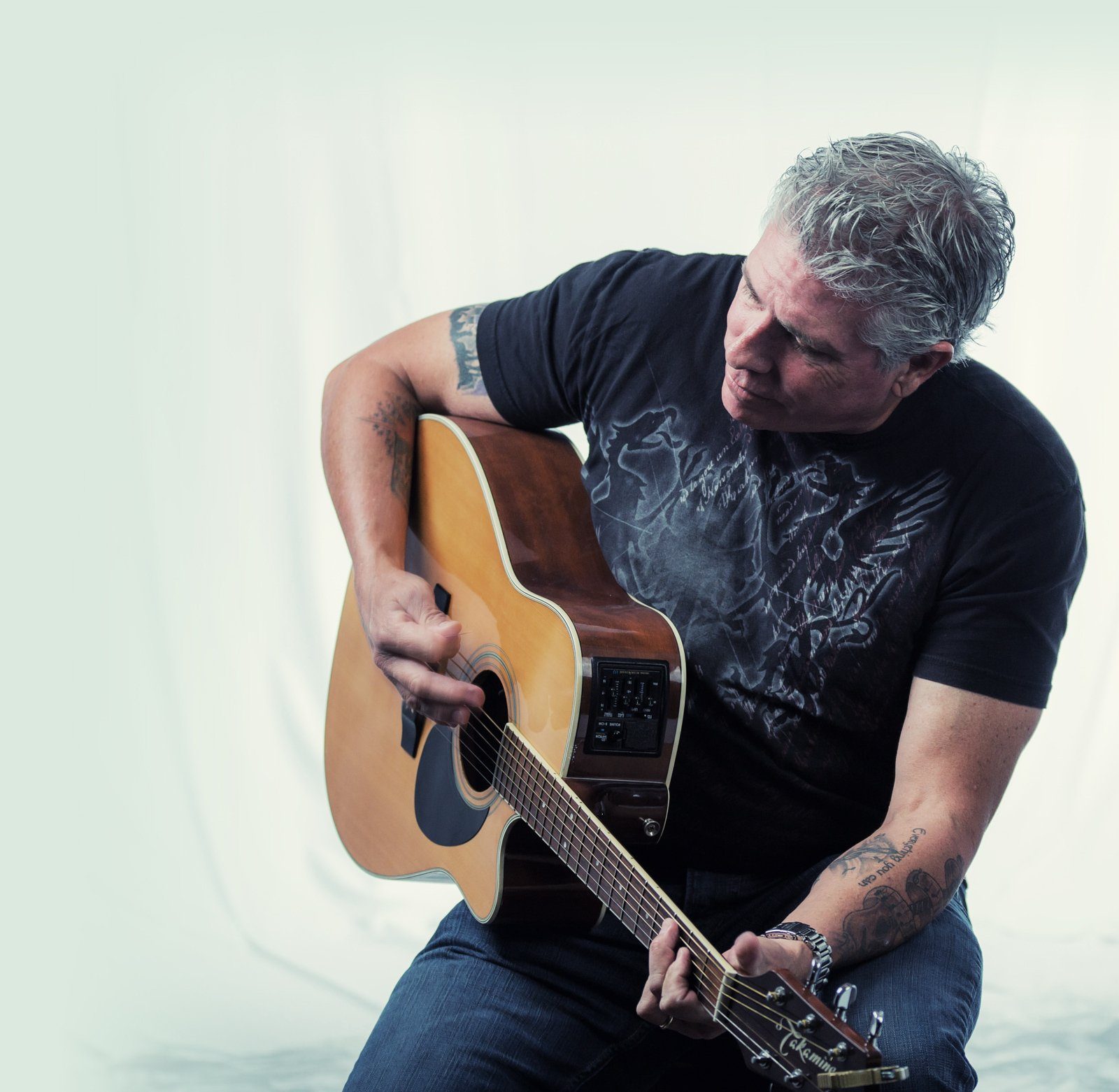 Tim McGeary in the recording studio with his guitar